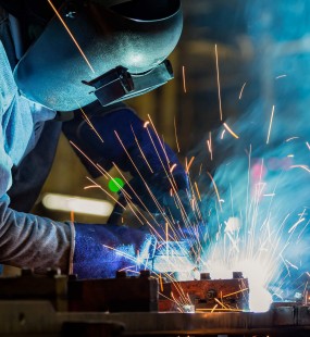 Image of someone crafting metal with sparks flying