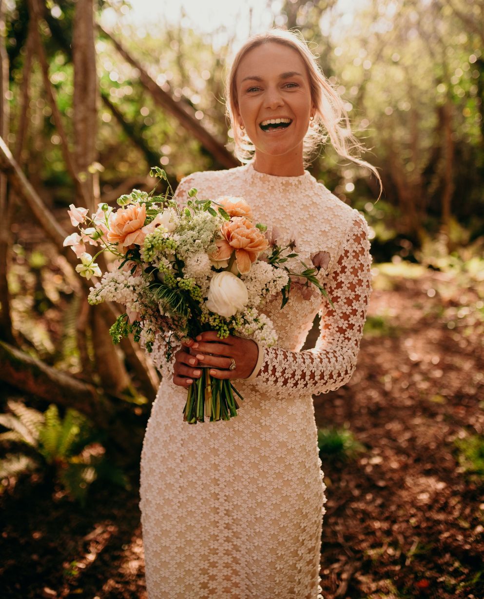 woman in a dress holding a bouquet of flowers