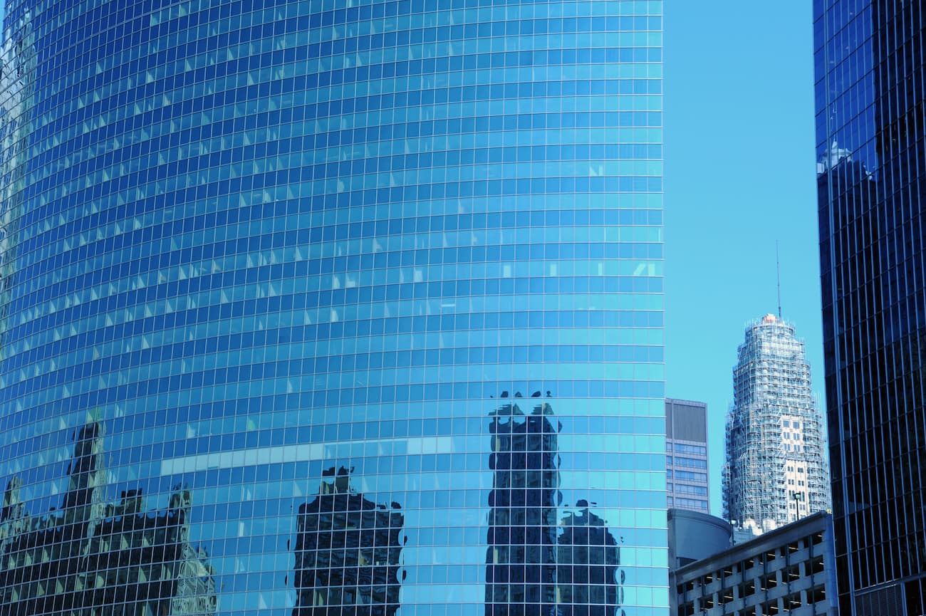 Glass building reflecting a blue sky