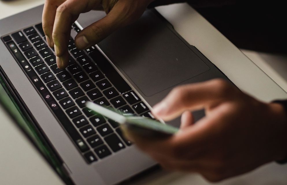 woman on her phone and laptop
