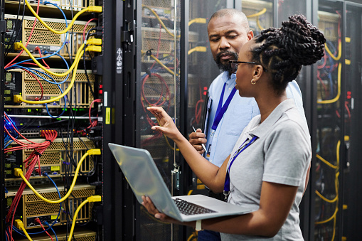 people checking systems in a server room