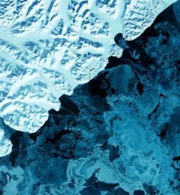The eastern side of Russia's Kamchatka Peninsula juts into the Pacific Ocean west of Alaska. In this winter image, a volcanic terrain is hidden under snow-covered peaks