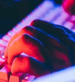 hands typing at the keyboard of a computer