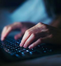 person typing on a laptop