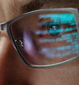 code reflected off glasses