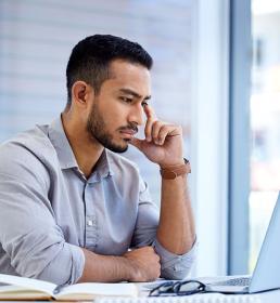 man looking at a laptop
