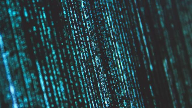 green computer code running vertical