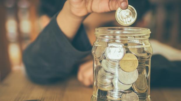 A child putting pennies in a jar