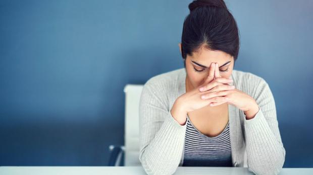 person with head in hands stress