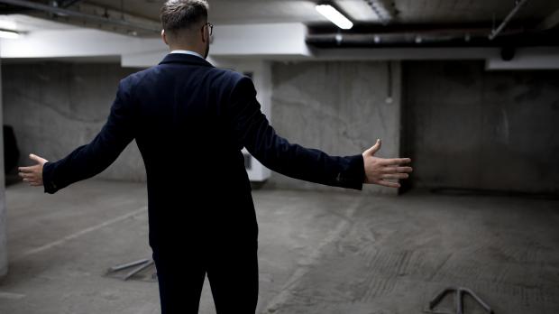 Bewildered man finding his car has been stolen in underground car park