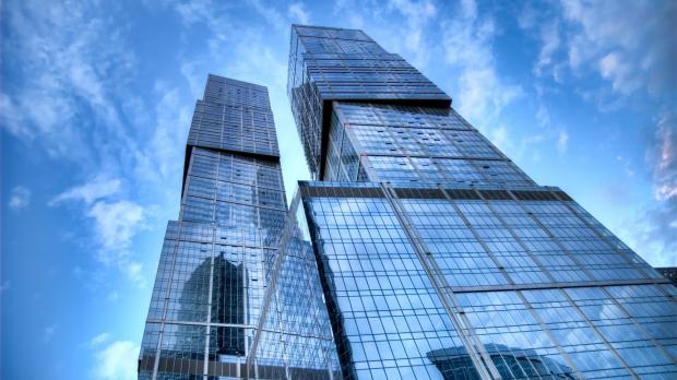skyscraper with clouds reflected in the glass