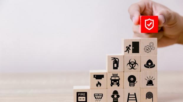Wooden blocks piled up depicting safety icons