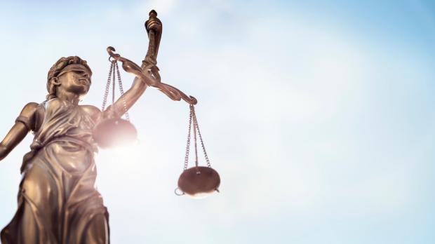 Lady Justice with the sky as background