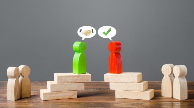 Wooden block people negotiating