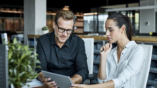 Colleagues looking at a laptop