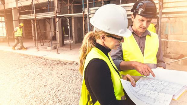 Construction site workers looking at plans