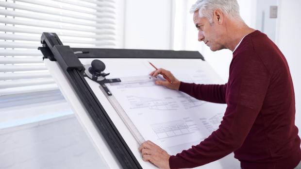 Male architect working on a plan