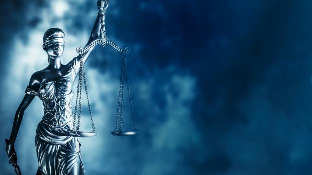 Lady Justice with storm clouds behind