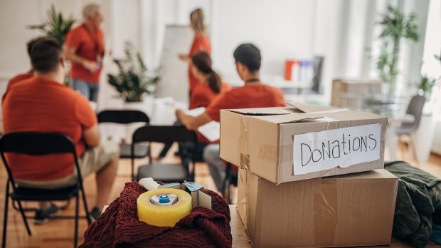 Meeting of charity members with donation boxes