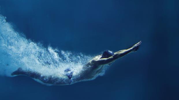 A diver swimming upward