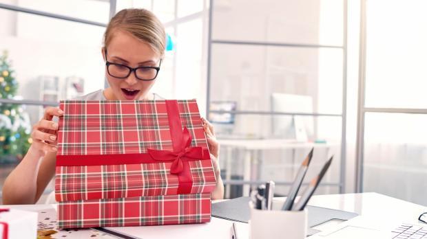 Woman opening Christmas present