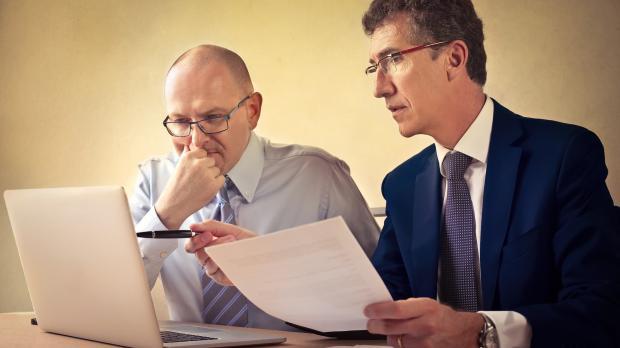 Solicitor and client reviewing content on a laptop