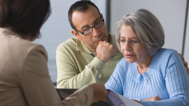 Man and Woman reading papers with their solicitor