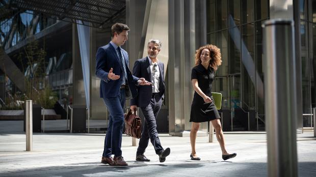 suited business people walking through city