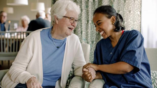Older lady sitting with a nurse