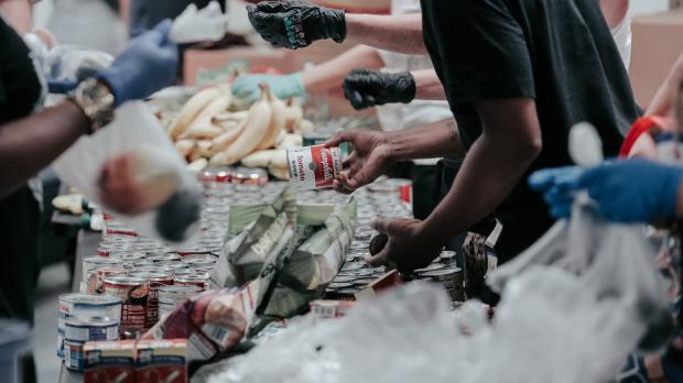 People handing out bags of food in a foodbank