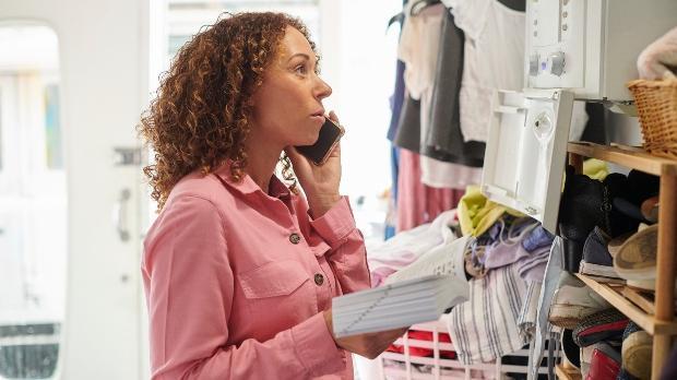 woman looking at instructions and boiler product