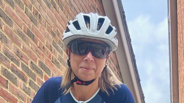 Alison Waters in triathlon kit with helmet and sunglasses on