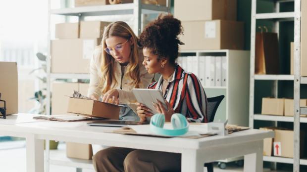 women looking at tablet in workspace