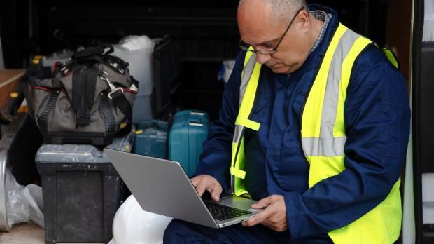 contractor looking at his laptop