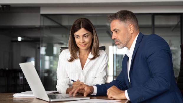 business people in a meeting working on a laptop
