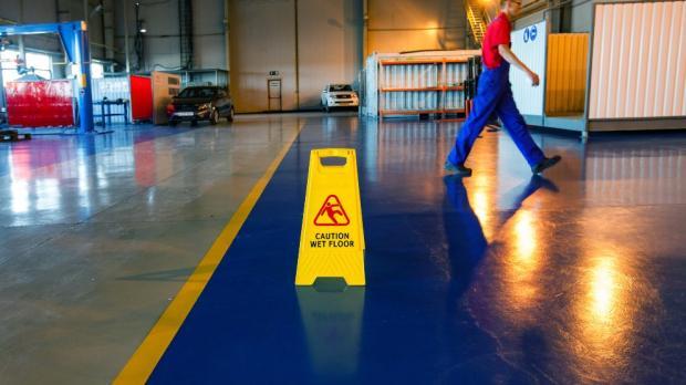 wet floor sign on the floor of a factory