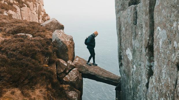 Top 5 claims risks solicitors | man crossing ravine