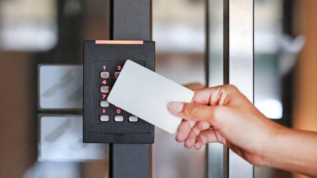 key card unlocking a door key pad