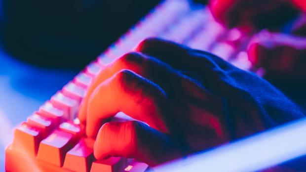 hands typing at the keyboard of a computer