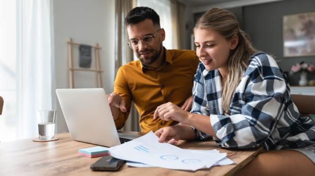 two people checking a laptop