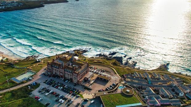 Aerial view of a coastal resort with waves crashing on the shore