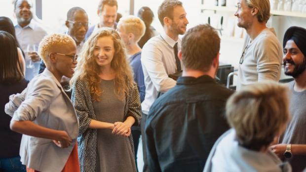 Diverse group of people socializing at a casual gathering. 