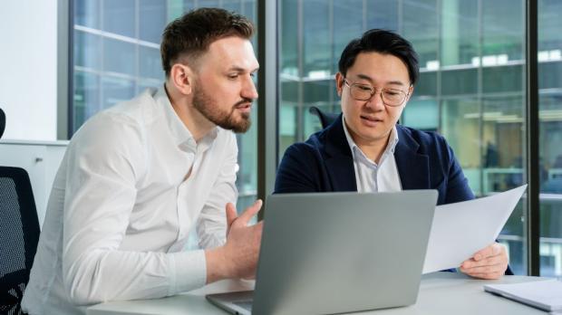 two men analyzing stats 