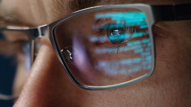 code reflected off glasses