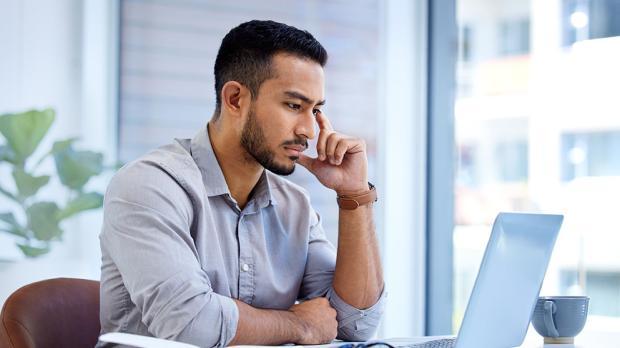 man looking at a laptop