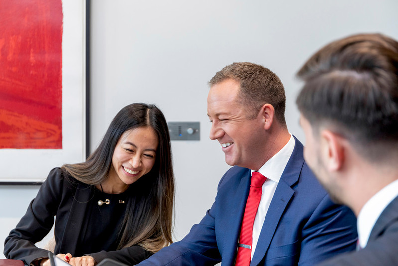 Howden Australia Banner of staff in a meeting smiling