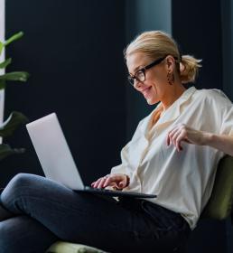 Happy Business Woman Using Laptop Computer In The Office