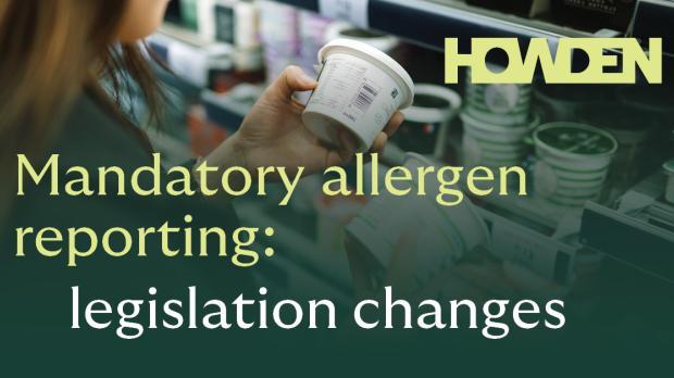 woman in a supermarket comparing food labels for allergens