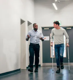 At hospital on crutches with doctor - workers compensation - Howden Belgium