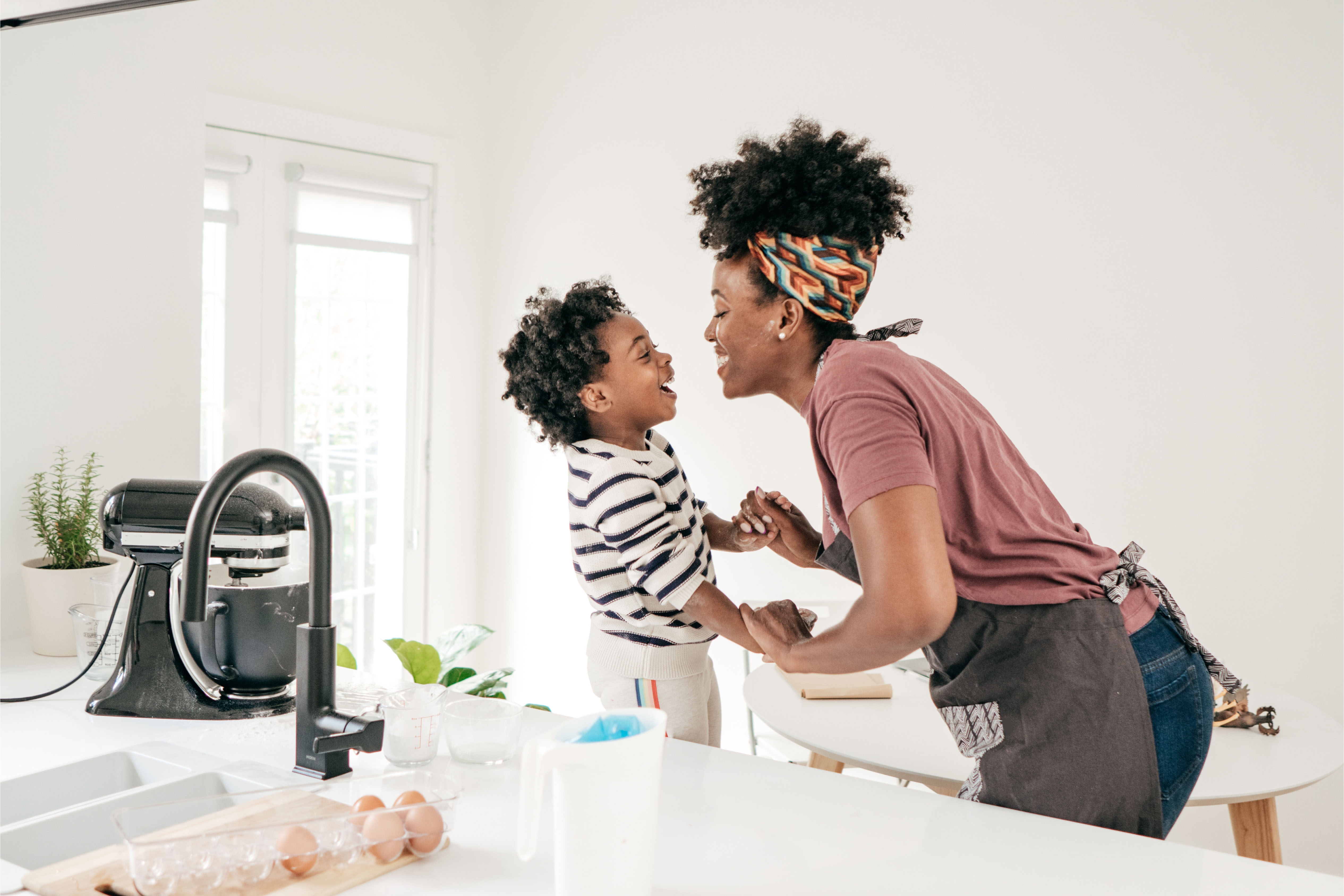 Mom and kid having fun in kitchen